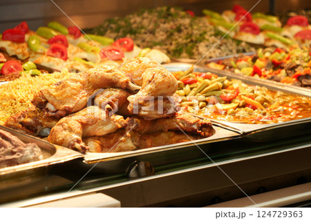 Indulge in Delicious Fried Chicken accompanied by Colorful Sides at a Charming Buffet Indulge in Delicious Fried Chicken accompanied by Colorful Sides at a Charming Buffet 124729363