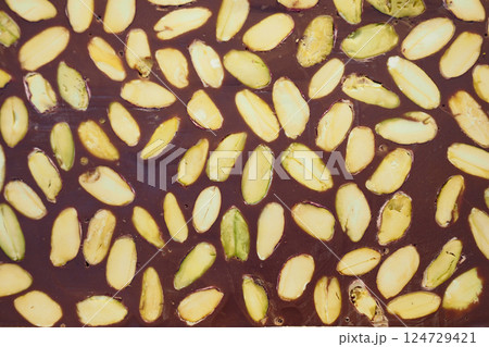 Enjoy rich Chocolate Bark with Almonds and Pistachios, ideal for any celebration Enjoy rich Chocolate Bark with Almonds and Pistachios, ideal for any celebration 124729421