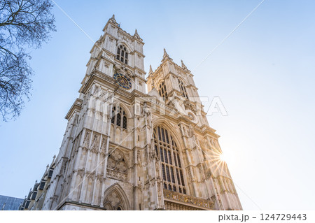 Sunlight shines on the historic Westminster Abbey, revealing its intricate architecture and towering spires. The scene captures a moment of tranquility in this iconic London landmark. Sunlight shines on the historic Westminster Abbey, revealing its intricate architecture and towering spires. The scene captures a moment of tranquility in this iconic London landmark. 124729443
