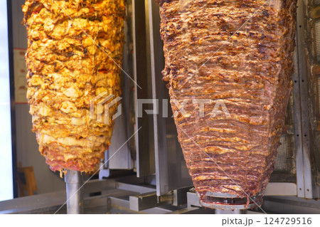 Delicious Shawarma is Rotating on Skewers in a Restaurant, a Culinary Delight to Enjoy Delicious Shawarma is Rotating on Skewers in a Restaurant, a Culinary Delight to Enjoy 124729516