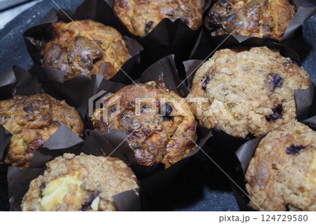 Indulge in Delicious and Freshly Made Homemade Muffins Served in Decorative Paper Cups Indulge in Delicious and Freshly Made Homemade Muffins Served in Decorative Paper Cups 124729580