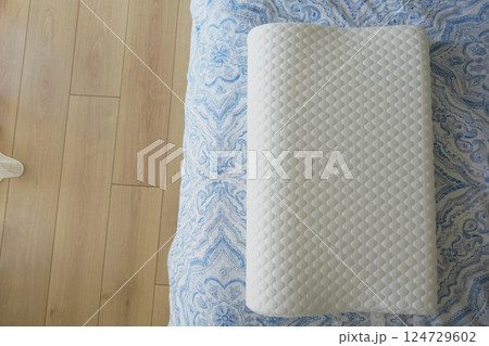 Orthopedic pillow on a bed  124729602