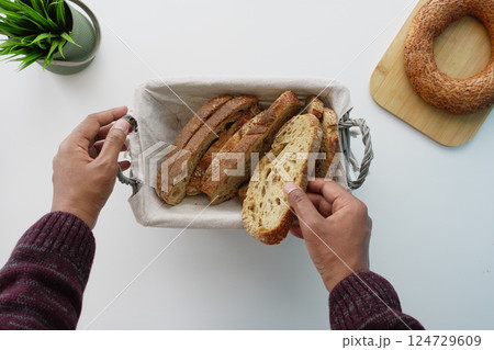 Enjoy Freshly Sliced and Made Homemade Bread, Perfectly Served in a Beautiful Serving Basket Enjoy Freshly Sliced and Made Homemade Bread, Perfectly Served in a Beautiful Serving Basket 124729609