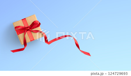 Present or gift box wrapped in brown craft paper and red ribbon on white background 124729693