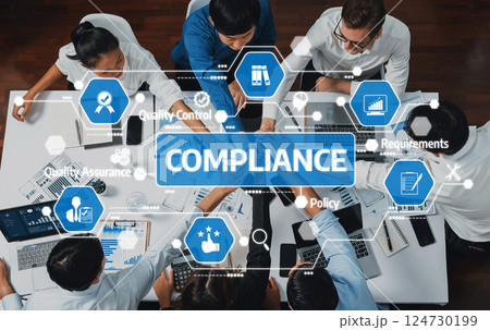 Diverse Team Collaborating on Compliance Strategies in a Modern Office Setting with Visual Data Analytics and Project Management Tools. Amity 124730199