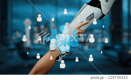 Human hand reaching out to robotic hand in futuristic environment with digital avatars and glowing icons representing connection and interaction between technology and people. Auvana Human hand reaching out to robotic hand in futuristic environment with digital avatars and glowing icons representing connection and interaction between technology and people. Auvana 124730325