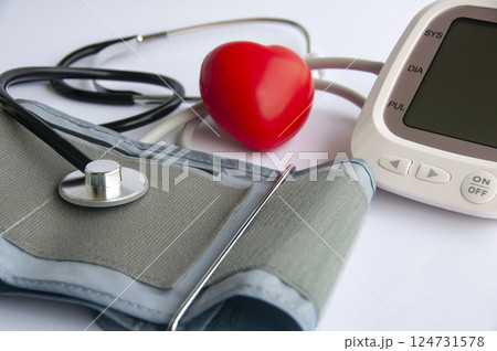 Side view of stethoscope, red heart shaped and blood pressure monitor with customizable space for text. Medical and health concept Side view of stethoscope, red heart shaped and blood pressure monitor with customizable space for text. Medical and health concept 124731578