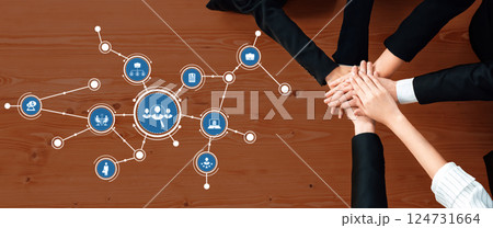 Collaborative Teamwork in Business Environment with Diverse Icons Representing Success and Innovation on Wooden Table Background. Amity 124731664