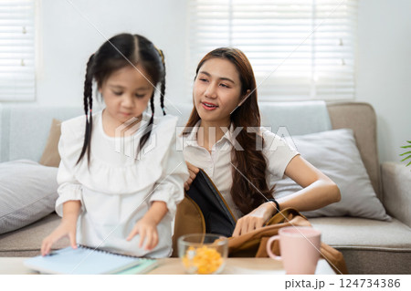 Back to School Preparation and Bonding. A mother helps her little daughter get ready for school with joy and support. 124734386