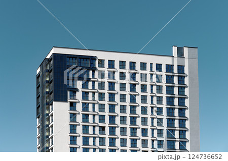 Building in downtown city. Tall modern highrise with office and residential accommodation, facade 124736652