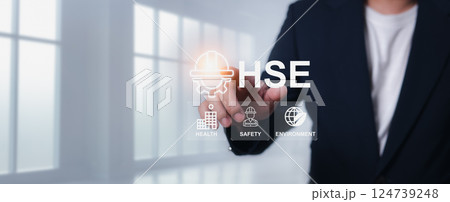 HSE, Health safety environment concept, Safety and protection in industrial work, Accident.Standard safe industrial work and industrial, Engineer Standing holding a hat with the HSE letter icon. 124739248
