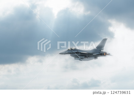 Fighter jet flies through the sky on technology background 124739631