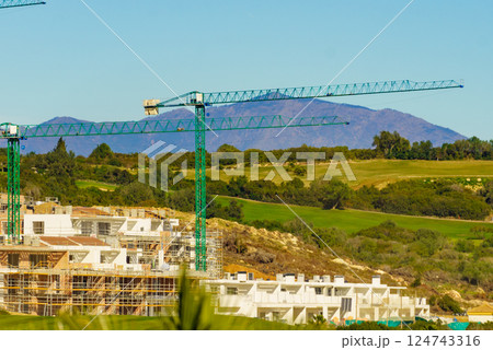 Spanish coast view with construction site with crane industrial equipment 124743316