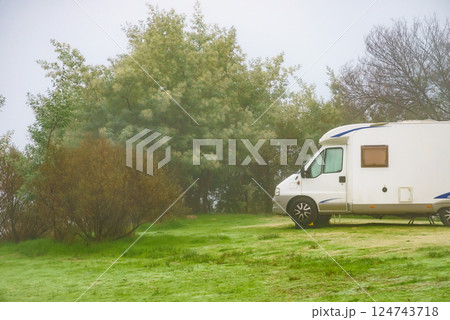 Camper rv camping on nature. Foggy day Camper rv camping on nature. Foggy day 124743718