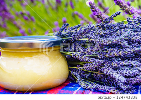 Jar with honey and lavender flowers. Jar with honey and lavender flowers. 124743838
