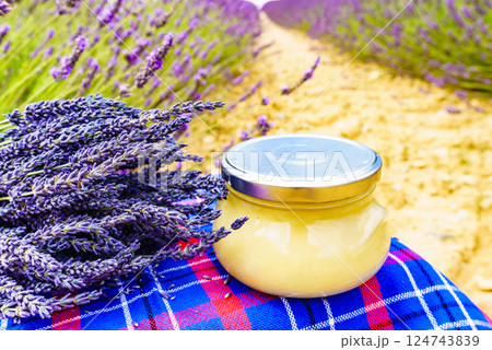 Jar with honey and lavender flowers. Jar with honey and lavender flowers. 124743839