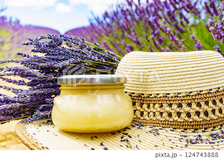 Summer hat and jar with honey at lavender field. Holidays in France. 124743888