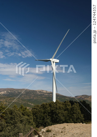 Against the background of the blue sky, a windmill Against the background of the blue sky, a windmill 124744357