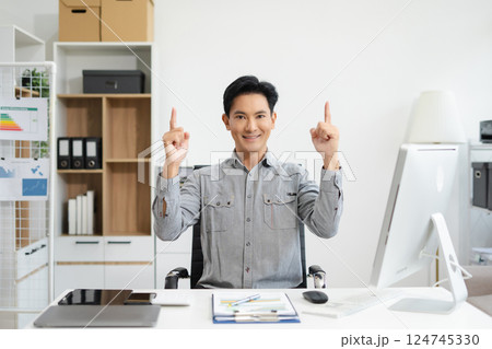 Happy mature businessman presenting or pointing, happy working. 124745330