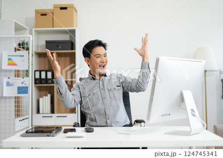 asian businessman are excited business success with inspiration from their excellent financial results that are happy working in a modern office on a computer. asian businessman are excited business success with inspiration from their excellent financial results that are happy working in a modern office on a computer. 124745341