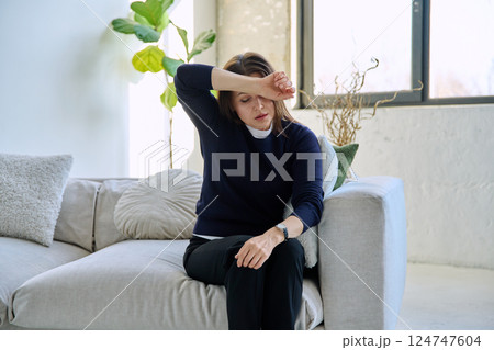 Mature sad woman experiencing stress, mental and physical pain, at home Mature sad woman experiencing stress, mental and physical pain, at home 124747604