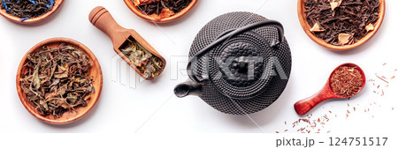 Loose tea leaves panorama with a tea pot. An assortment of various teas Loose tea leaves panorama with a tea pot. An assortment of various teas 124751517