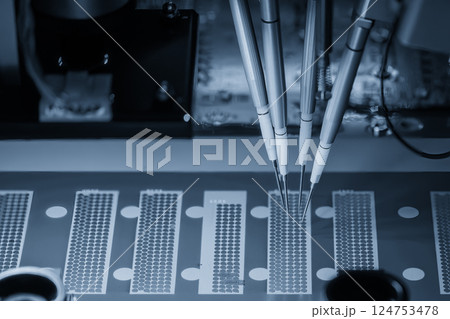 The PCB board checking process by high speed automatic robot system in the light blue scene. 124753478