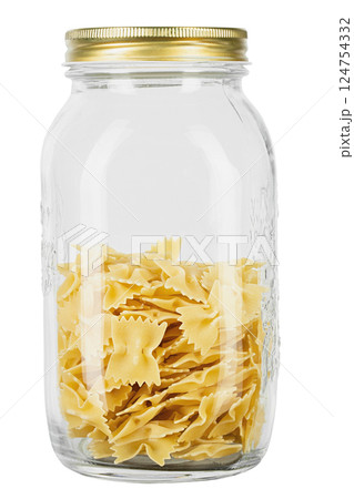 Farfalle pasta in a glass jar for storing bulk products isolated on white background. 124754332