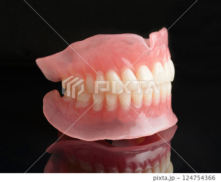 Full denture dentures on black. 124754366