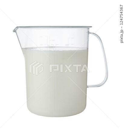 Milk in a plastic measuring cup isolated. 124754367