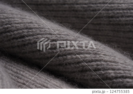 Gray woolen knitted scarf. View texture, close-up macro. Gray woolen knitted scarf. View texture, close-up macro. 124755385