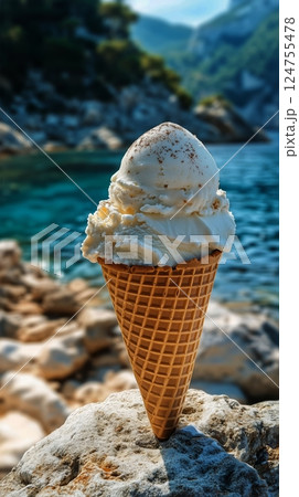 Enjoying a Delicious Ice Cream Cone by the Tranquil Blue Water in a Scenic Outdoor Location 124755478