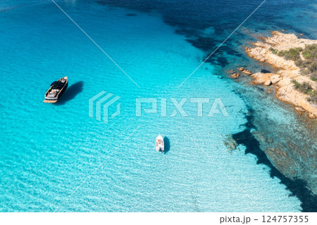 Aerial view of luxury yacht and boat in blue sea in summer Aerial view of luxury yacht and boat in blue sea in summer 124757355