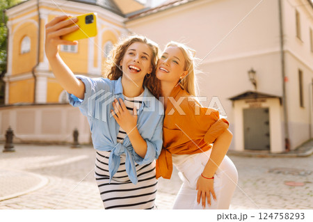 Young friends having fun and take selfie on the phone together. Entertainment, youth concept. 124758293