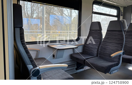 Modern Train Interior with Comfortable Seating and Large Windows 124758900