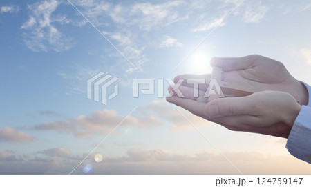 Christian prayer. Man on his knees praying on sunset background. Kneeling prayer to God. 124759147