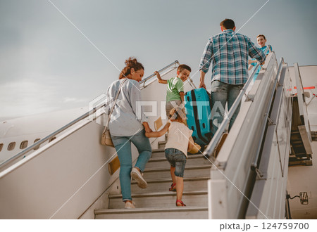 A Family Joyfully Boarding an Airplane, Eagerly Anticipating Their Exciting Vacation Adventure 124759700