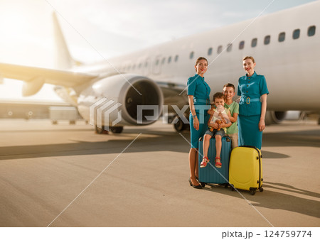 Traveling as a family together with the flight crew at the bustling airport environment Traveling as a family together with the flight crew at the bustling airport environment 124759774