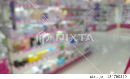 Blurred interior of a brightly lit store with colorful shelves 124760329