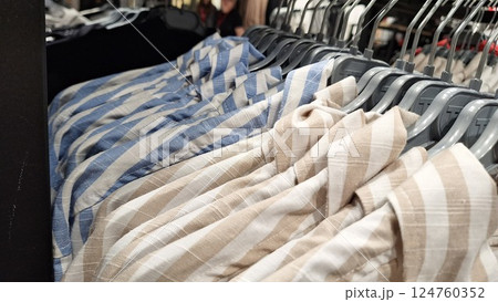 Striped shirts on display in clothing store 124760352