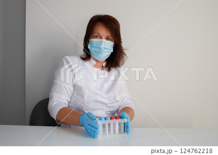 Medical laboratory nurse preparing test tubes for making blood tests 124762218