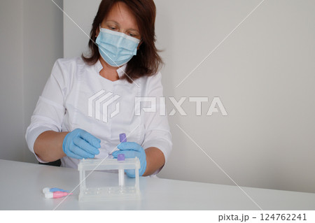 Medical laboratory nurse preparing workplace for making children blood tests Medical laboratory nurse preparing workplace for making children blood tests 124762241
