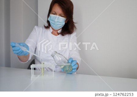 Medical laboratory nurse making urine test Medical laboratory nurse making urine test 124762253