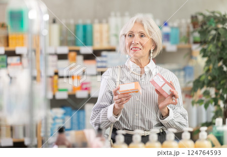 Mature woman choosing paracetamol at the pharmacy 124764593