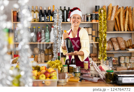 Woman seller in Santa Claus hat with food Woman seller in Santa Claus hat with food 124764772