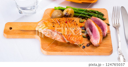 Roasted duck breast with baked onions, asparagus 124765037