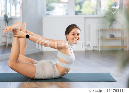 Young woman practicing hatha yoga in studio Young woman practicing hatha yoga in studio 124765114