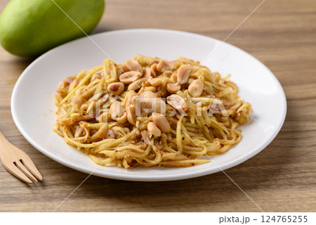 Spicy mango salad on white plate, Thai food Spicy mango salad on white plate, Thai food 124765255