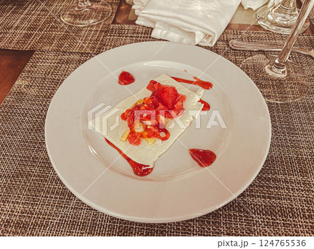 Crepes with strawberry sauce on a white plate in a restaurant Crepes with strawberry sauce on a white plate in a restaurant 124765536