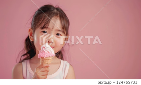 Little girl eating vanilla ice cream dessert in summer copy space isolated pink background 124765733